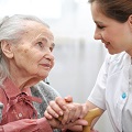 Senior woman with her caregiver at home